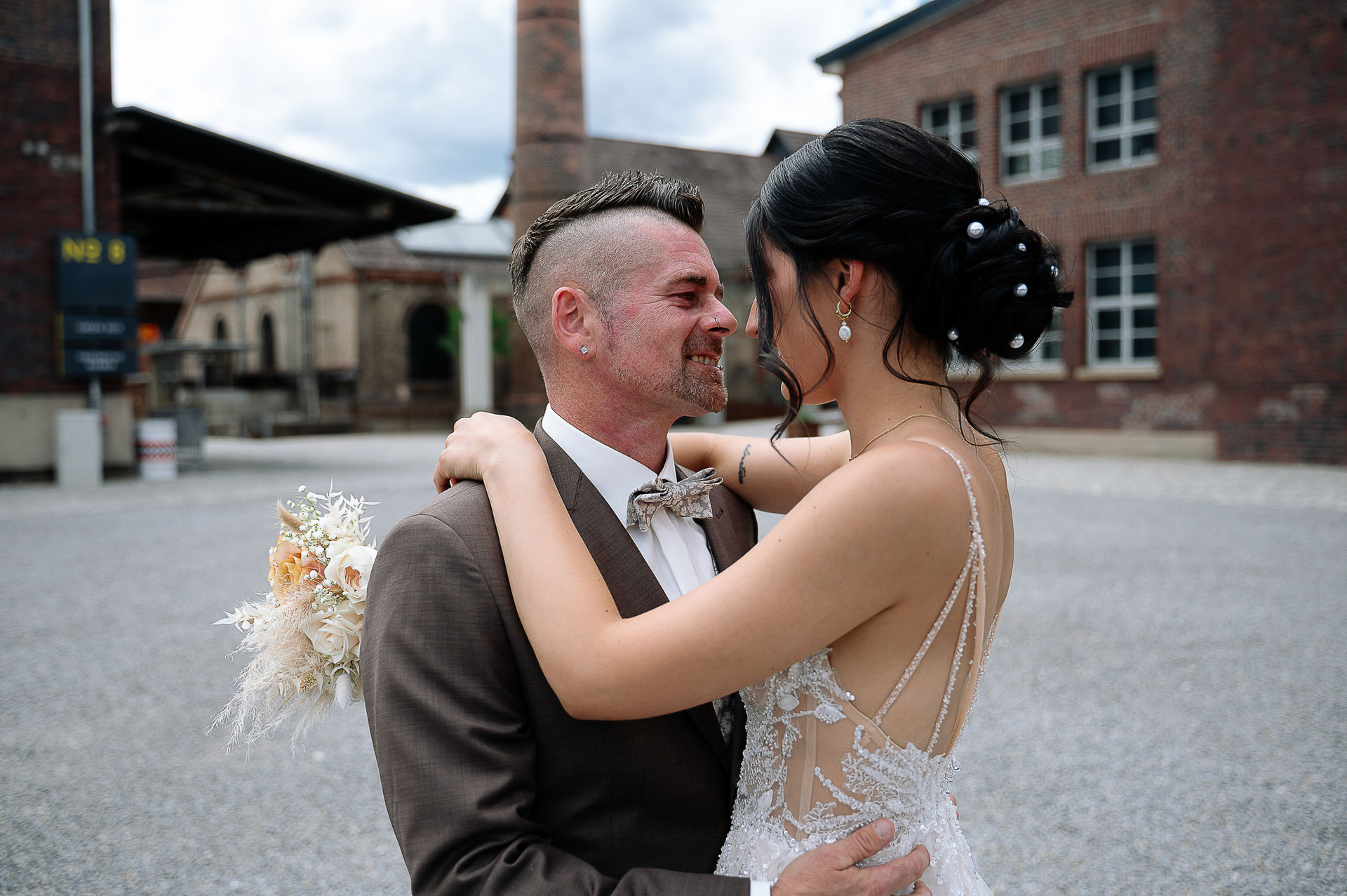 Romantisches Brautpaarshooting von Sara und Olli in der Motorworld Village Metzingen. Die einzigartige Kombination aus historischem Industriecharme und moderner Architektur schafft eine außergewöhnliche Kulisse für emotionale Hochzeitsfotos. Fotografiert von Nina Sander Photografie.