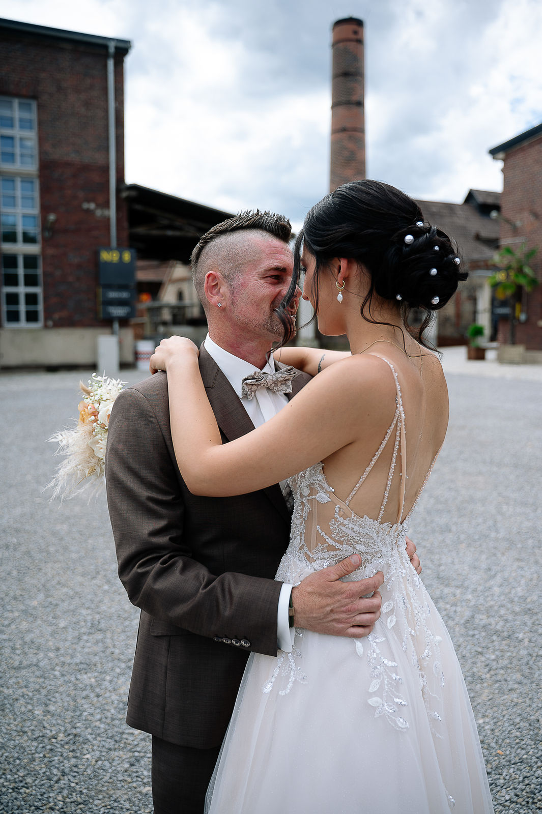 Romantisches Brautpaarshooting von Sara und Olli in der Motorworld Village Metzingen. Die einzigartige Kombination aus historischem Industriecharme und moderner Architektur schafft eine außergewöhnliche Kulisse für emotionale Hochzeitsfotos. Fotografiert von Nina Sander Photografie.
